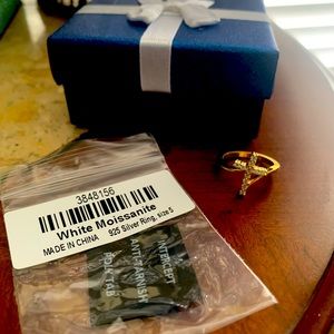 Beautiful cross ring with moissanite gemstones and gold over sterling silver.